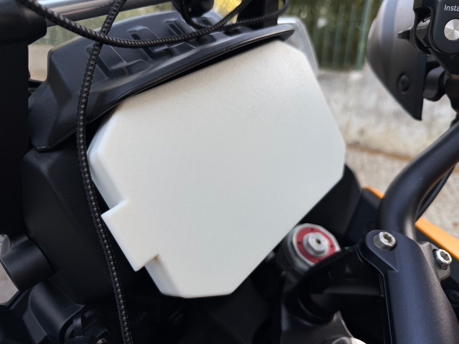 White 3D-printed dash cover fitted over the TFT instrument screen of a Moto Guzzi Stelvio.